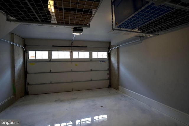 garage featuring a garage door opener and baseboards