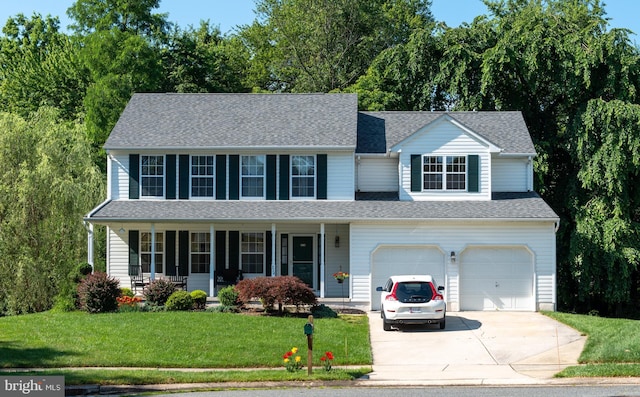 view of front of house featuring a porch, a shingled roof, concrete driveway, a garage, and a front lawn