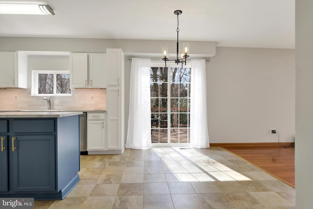 kitchen featuring light countertops, white cabinets, and decorative backsplash