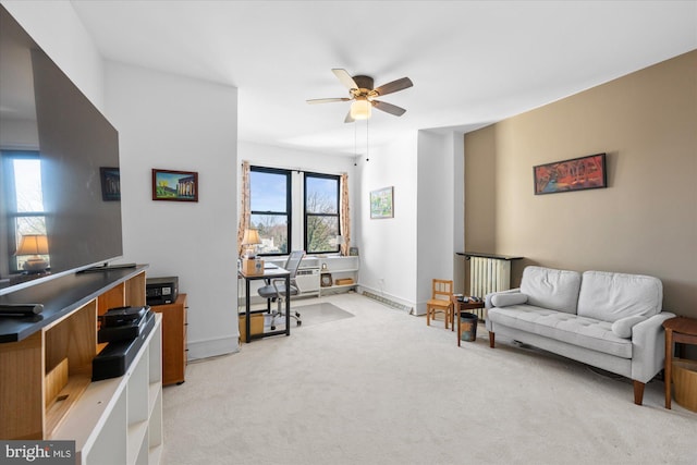 interior space featuring light carpet, a ceiling fan, and baseboards