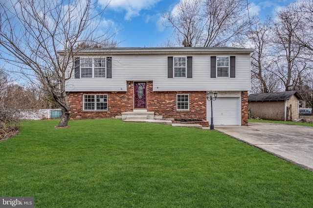 bi-level home with a garage, a front yard, concrete driveway, and brick siding