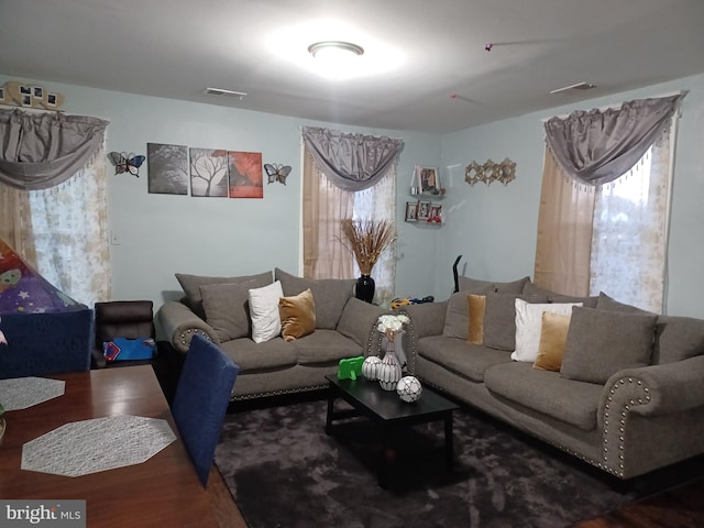 living room with wood finished floors and visible vents