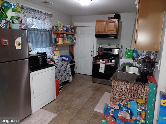 kitchen with washer / dryer, visible vents, dark countertops, appliances with stainless steel finishes, and under cabinet range hood