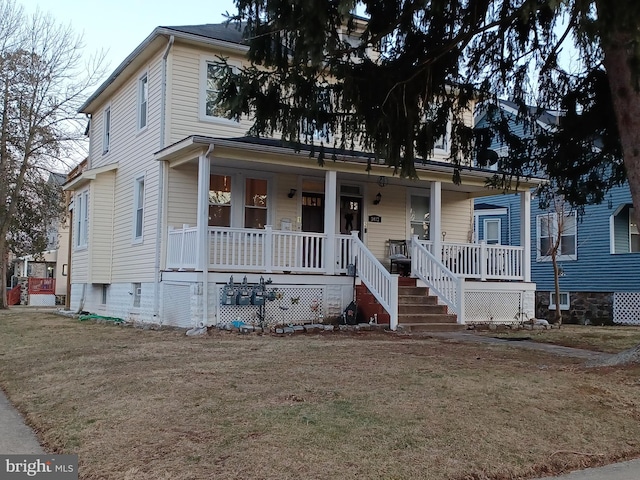 view of front facade with a porch and a front lawn