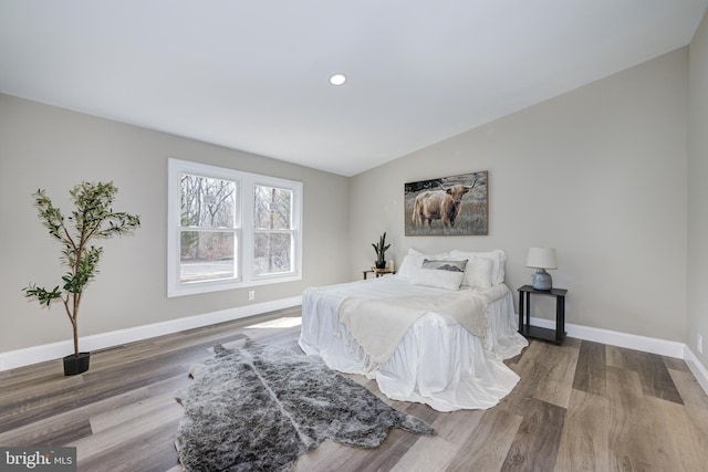 bedroom featuring recessed lighting, lofted ceiling, baseboards, and wood finished floors