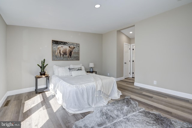 bedroom featuring recessed lighting, baseboards, and wood finished floors