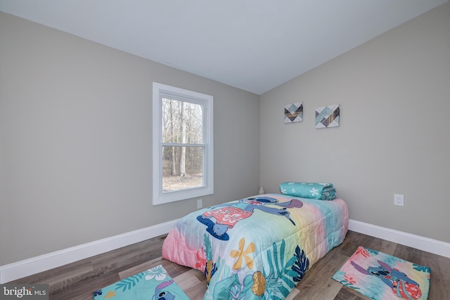 bedroom featuring baseboards and wood finished floors