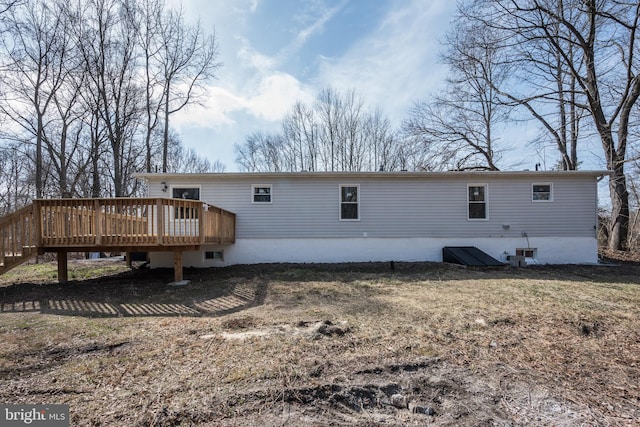 rear view of property with a wooden deck