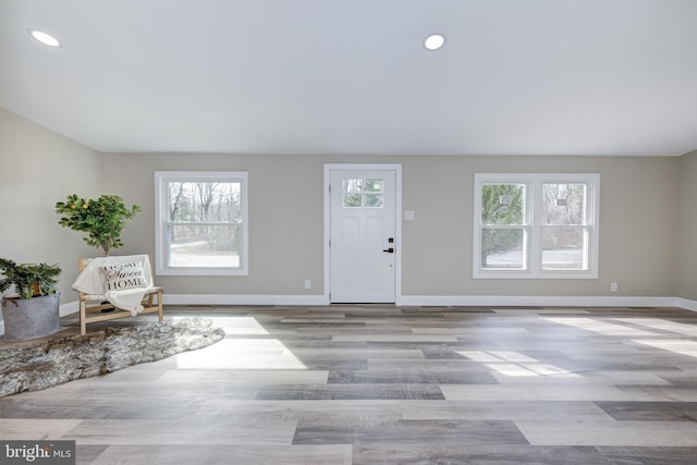 entryway featuring recessed lighting, wood finished floors, and baseboards