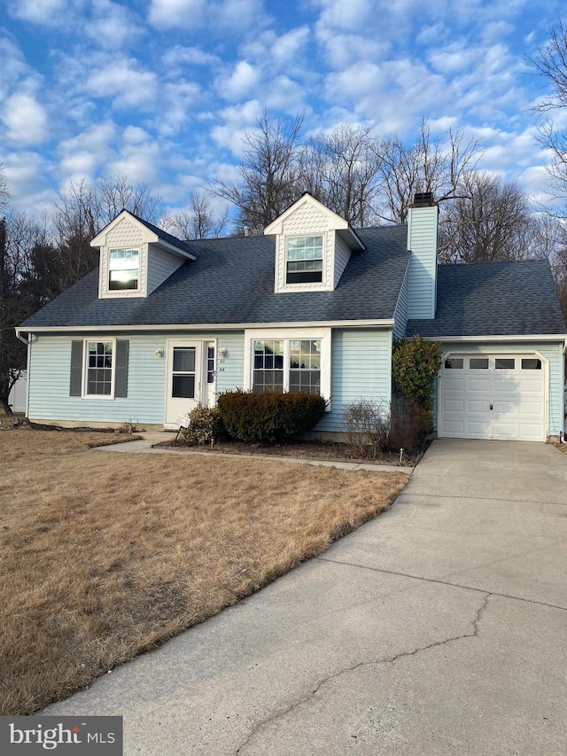 cape cod house with a garage, concrete driveway, a shingled roof, and a front lawn