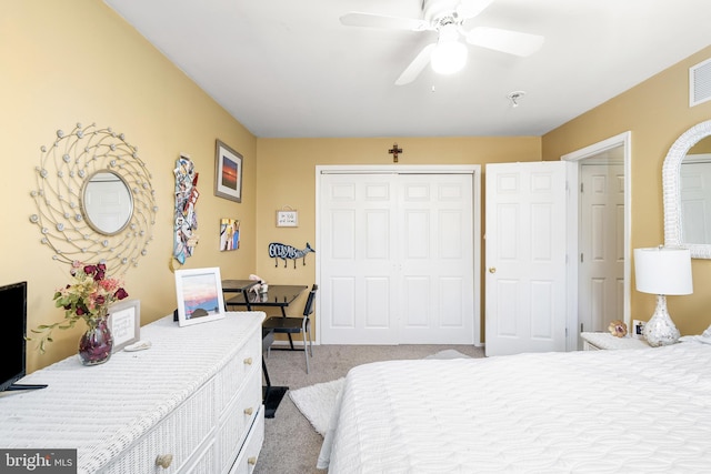 carpeted bedroom with a ceiling fan and a closet