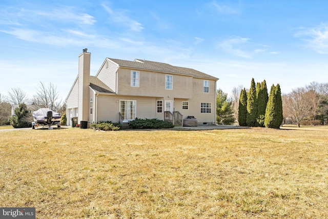 rear view of property featuring a yard and a chimney