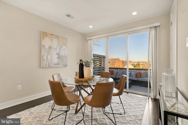 dining area featuring dark wood-type flooring, recessed lighting, visible vents, and baseboards