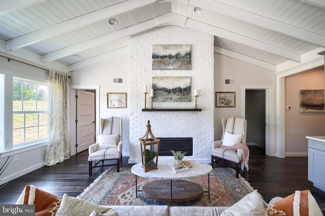 living room featuring vaulted ceiling with beams, dark wood-style flooring, and a brick fireplace