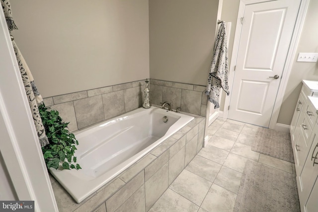 bathroom with a bath, tile patterned flooring, and vanity