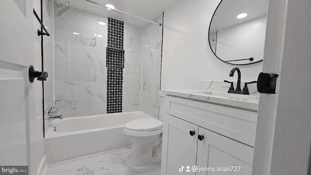 bathroom featuring marble finish floor, vanity, shower / tub combination, and toilet