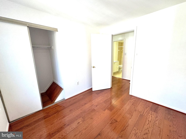 unfurnished bedroom with a closet and wood finished floors