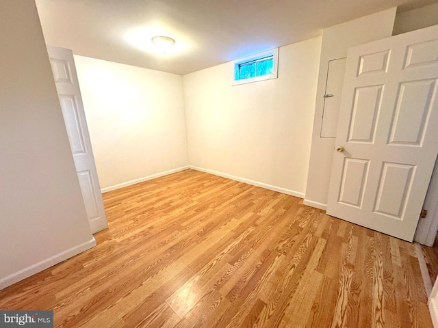 basement with light wood-style floors and baseboards