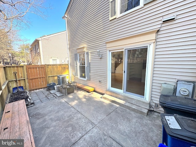 view of patio / terrace featuring central air condition unit and fence