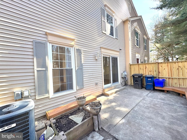 view of patio featuring fence and central AC