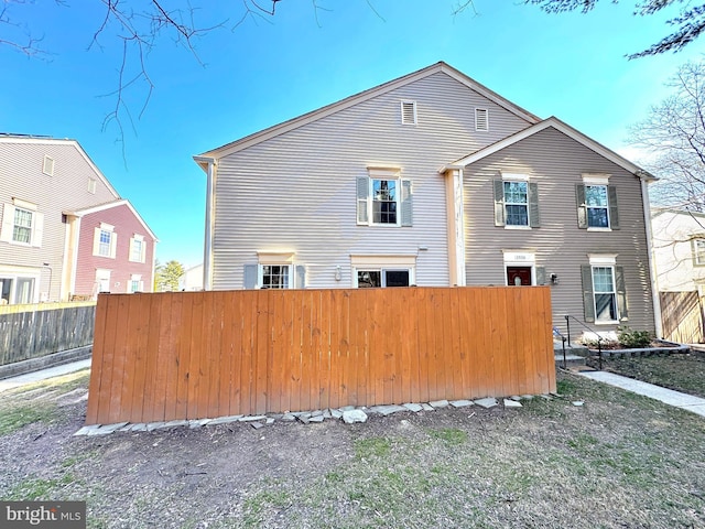 back of property featuring fence