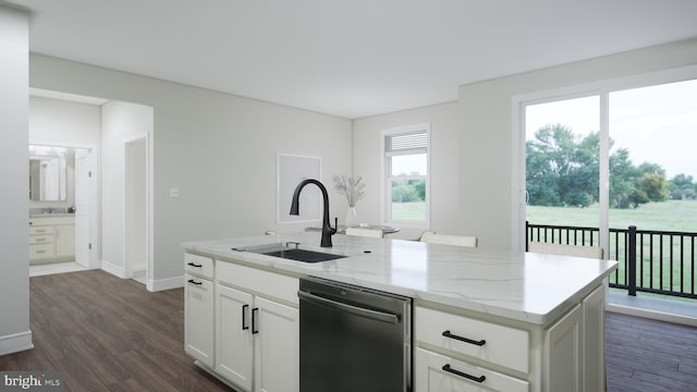 kitchen featuring light stone counters, a kitchen island with sink, a sink, white cabinets, and stainless steel dishwasher