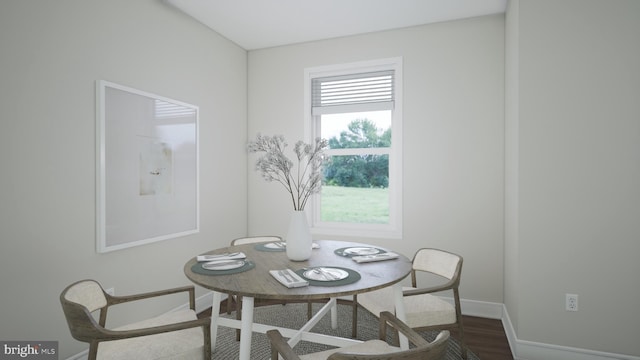 dining space with baseboards and wood finished floors