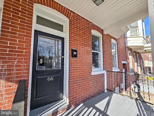 entrance to property with brick siding