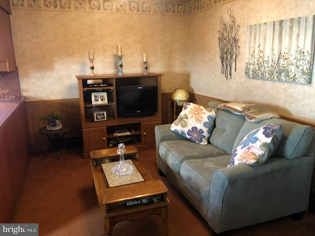 carpeted living area with a wainscoted wall and wallpapered walls