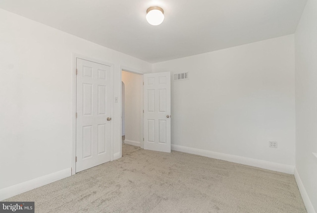 unfurnished bedroom featuring carpet floors, visible vents, and baseboards