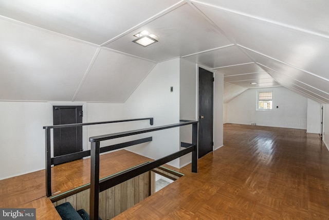 additional living space featuring lofted ceiling and wood finished floors