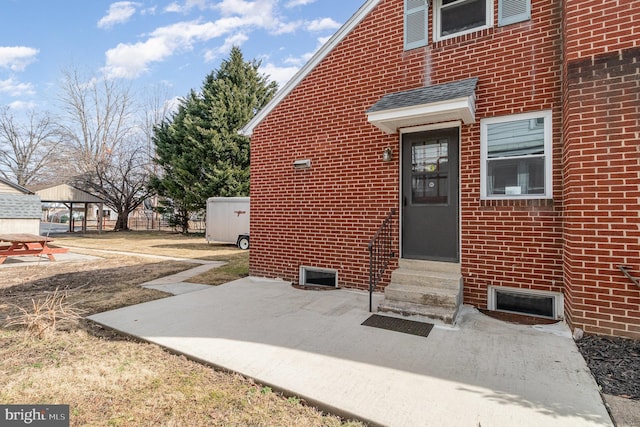 doorway to property with brick siding