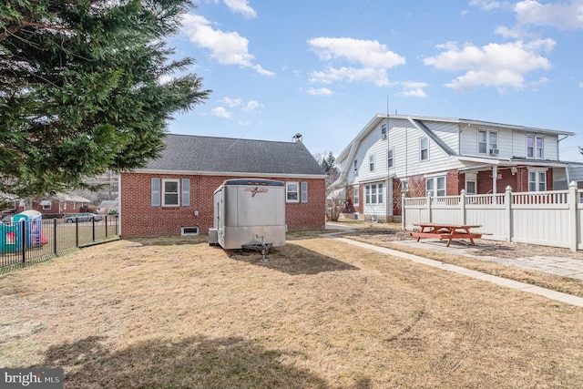 view of front of home with fence and brick siding