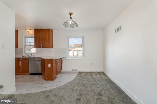 kitchen with visible vents, brown cabinetry, and stainless steel dishwasher