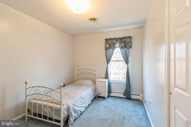 carpeted bedroom with visible vents, a baseboard heating unit, and baseboards