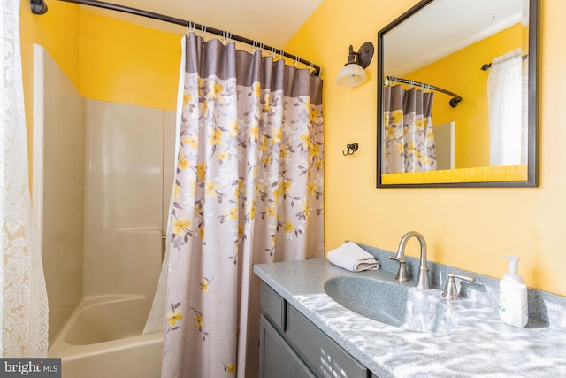 bathroom featuring shower / bath combo with shower curtain and vanity