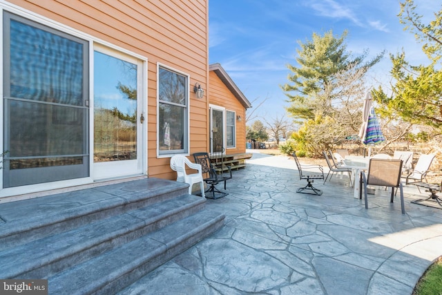 view of patio / terrace with entry steps and outdoor dining space