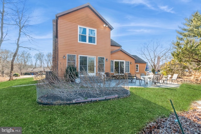 rear view of house with a yard and a patio area