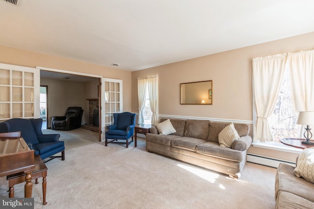 living area featuring light carpet, a baseboard radiator, and visible vents