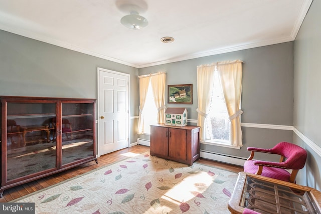 living area featuring ornamental molding, light wood-type flooring, visible vents, and a baseboard radiator