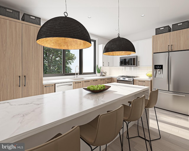 168 W Berks St, Philadelphia, PA 19122 - kitchen featuring decorative backsplash, appliances with stainless steel finishes, pendant lighting, and a sink