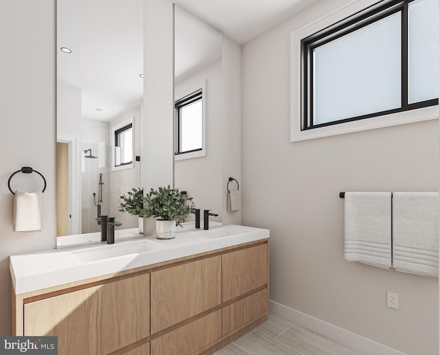 168 W Berks St, Philadelphia, PA 19122 - full bathroom featuring a sink, a shower stall, baseboards, and double vanity