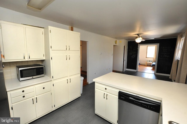 kitchen featuring ceiling fan, stainless steel appliances, a peninsula, light countertops, and tasteful backsplash