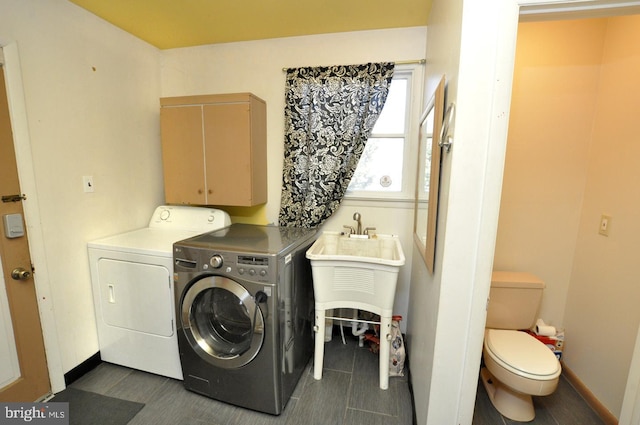 laundry room featuring laundry area, washer and clothes dryer, and baseboards