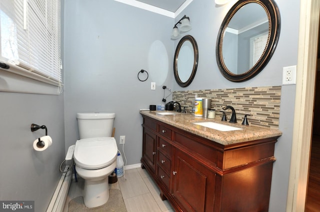 bathroom featuring toilet, tasteful backsplash, double vanity, and a sink