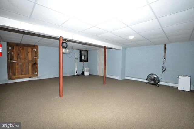 finished below grade area featuring carpet floors, electric panel, and a drop ceiling