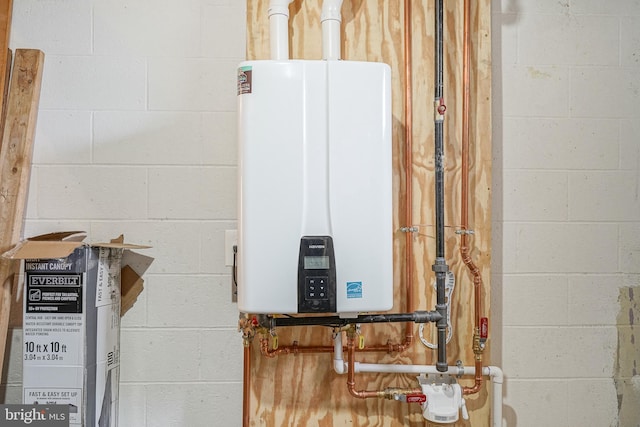 utility room featuring tankless water heater