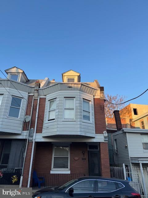 view of property with brick siding