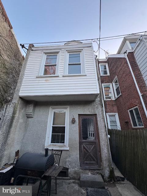 townhome / multi-family property with fence and stucco siding