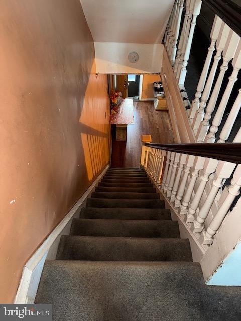 stairway with wood finished floors